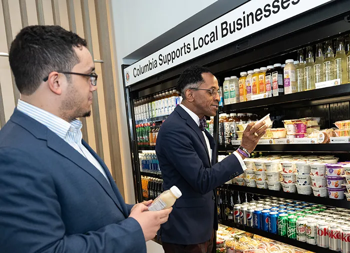 Council Member Shaun Abreu and Assembly Member Al Taylor inspect the local vendors on display in the Cafe on the ground floor of David Geffen Hall. 