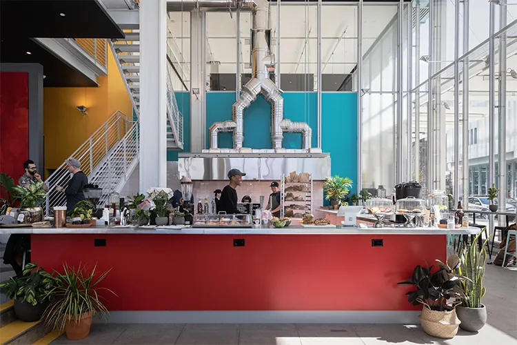 A bustling coffee shop with bright colors on Manhattanville campus.