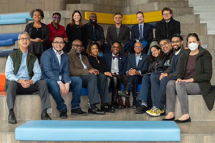 Rows of local elected leaders sit in the Geffen Hall Lobby for a class day-style picture. 