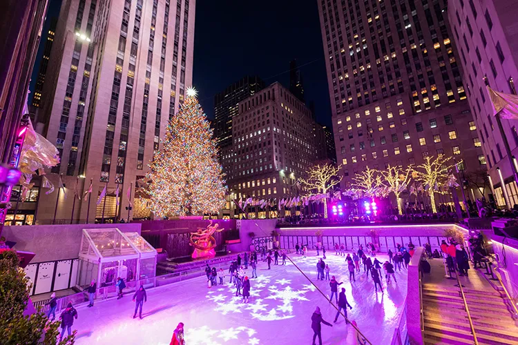 Ice skaters enjoy skating at the rink near the Christmas Tree at Rockefeller Center.