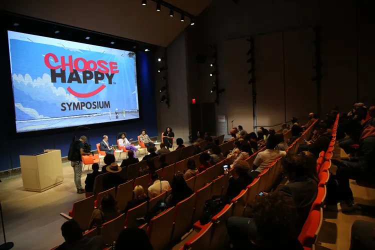 An auditorium with a panel of community leaders in the cannabis industry. 