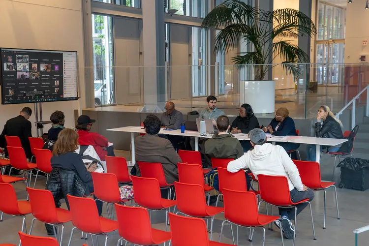 A group of community board members gather at The Forum. 