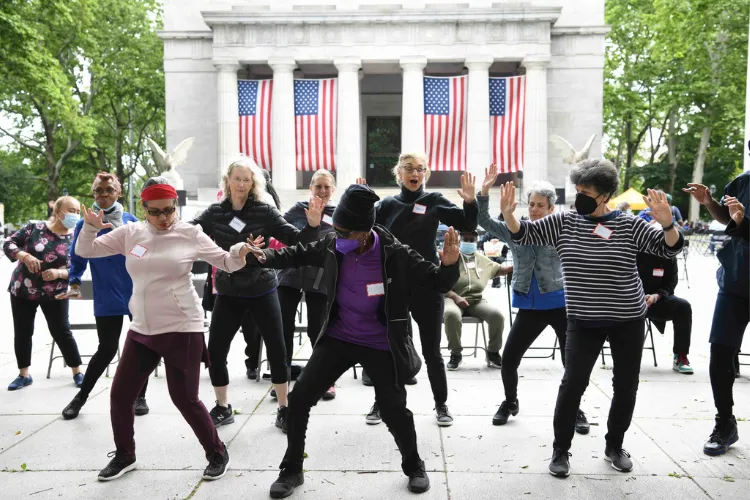 Elder adults dancing at Grants Tomb in Riverside Park. 