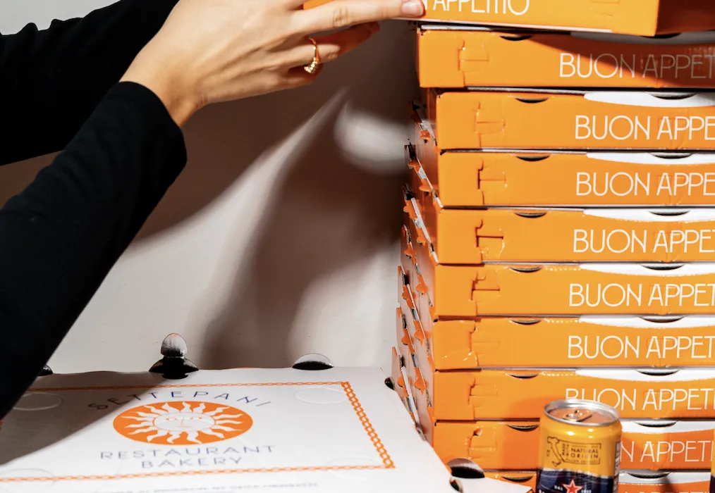 A pile of decorative pizza boxes on display.