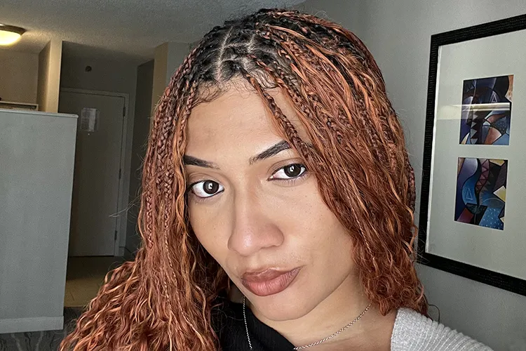 A young woman with red hair poses for a selfie photo.
