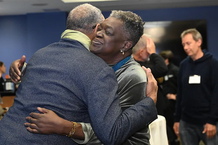A man and a woman embrace in a hug. 
