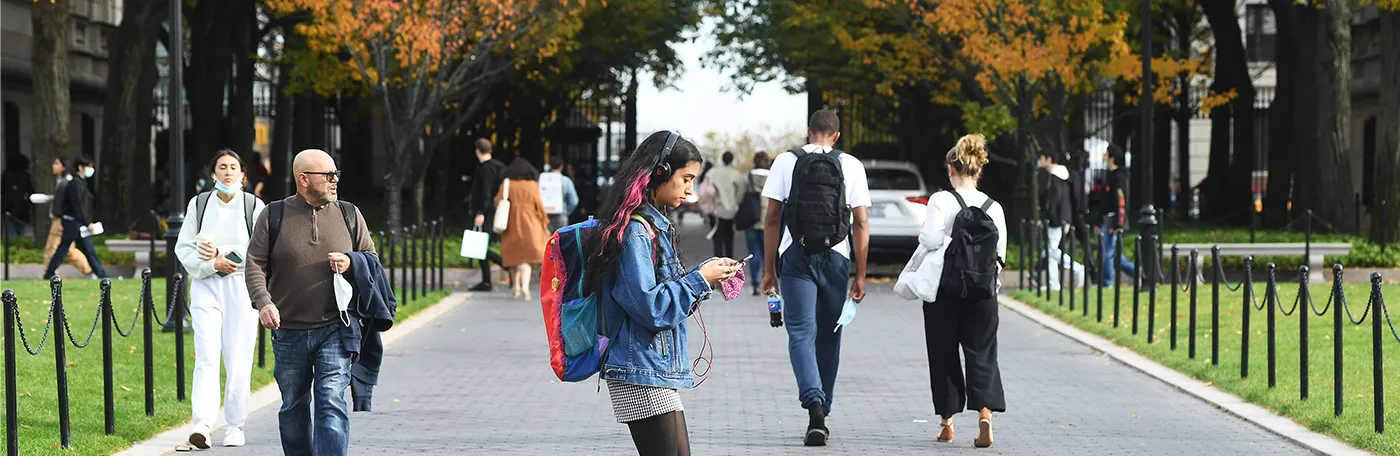 People walk on College Walk in the fall. 