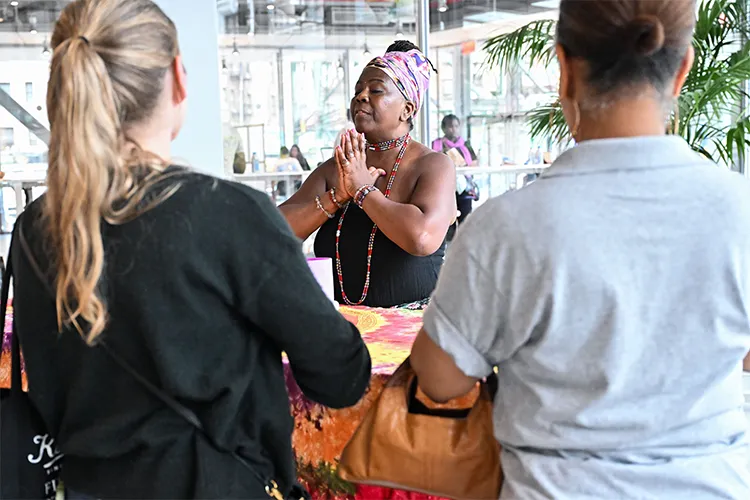 Two attendees engage in meditation at Manhattanville Community Day. 
