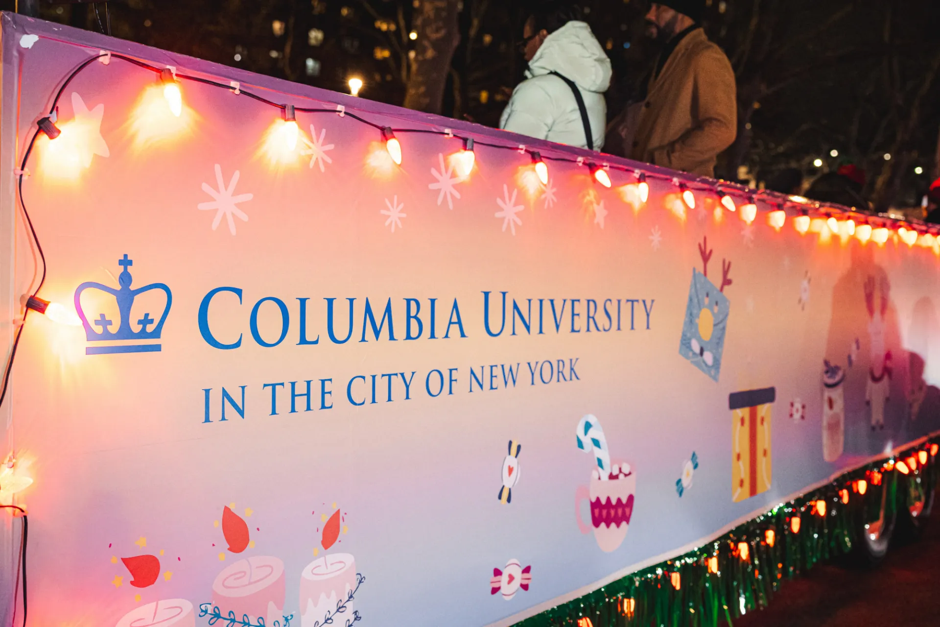 Community members load up on the Columbia University float during the Harlem Holiday Lights Parade. Photo credit: Brandon Vallejo