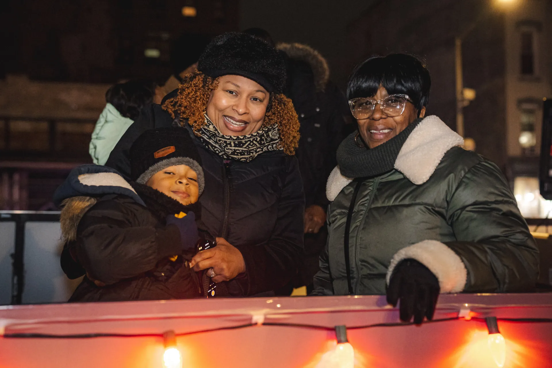 Community members enjoying the festivities at the Harlem Holiday Lights Parade. Photo credit: Brandon Vallejo