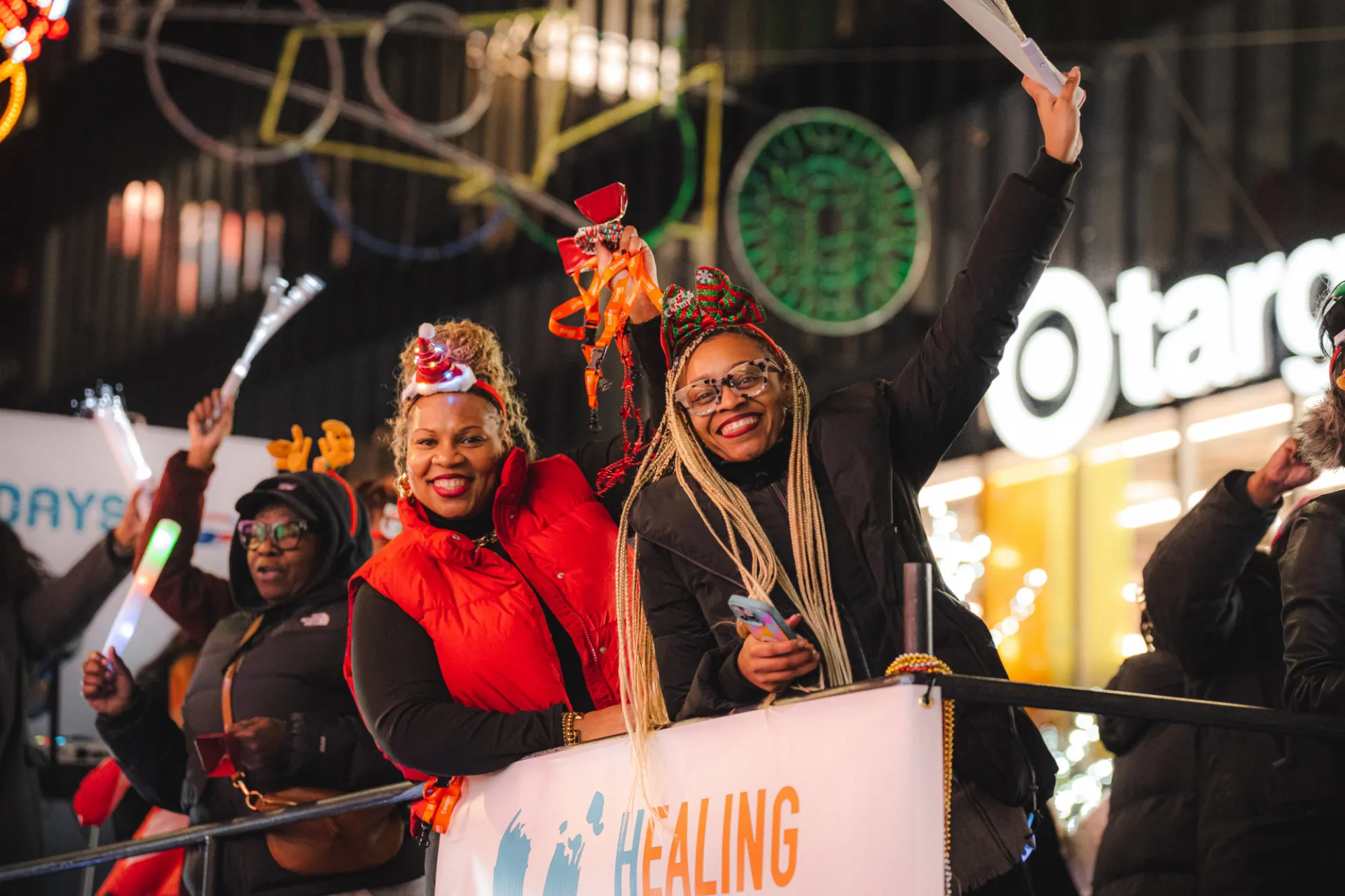Neighbors cheering on a float throughout the Harlem Holiday Lights Parade. Photo credit: Brandon Vallejo