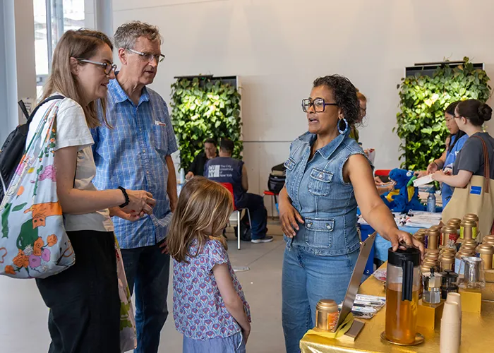 Attendees look at Botanical Moments tea options in the Lee C. Bollinger Forum. 