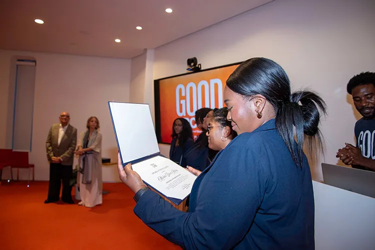 A Good Ground participant looks at a certificate.