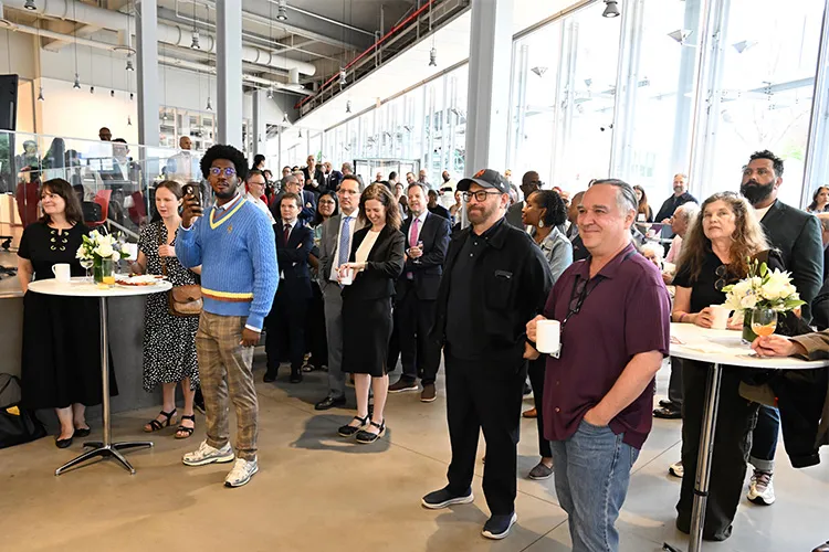 A crowd of local elected officials, community leaders, neighbors, and University affiliates.