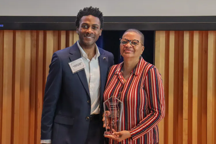 Joan Griffith Lee accepts the 2026 Public Service Award from 