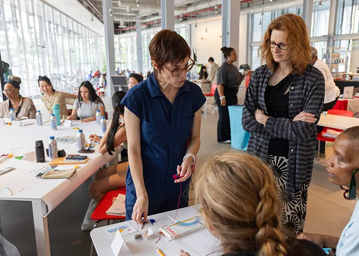 Maya Ciarrocchi leading a sewing circle in the Lee C. Bollinger Forum. 