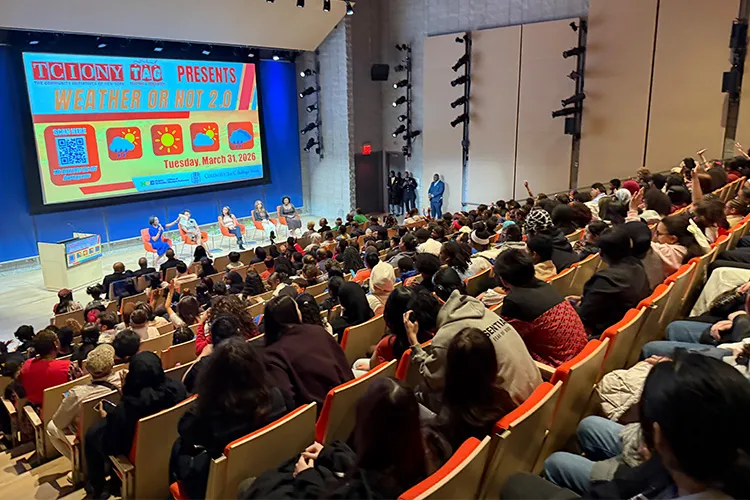 A large group of youth and panelists join together in The Forum’s auditorium. 