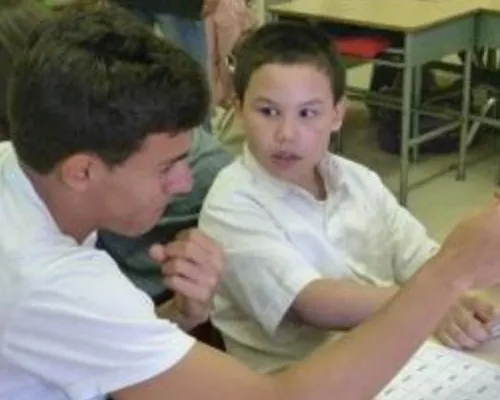 Mentor reading to child.