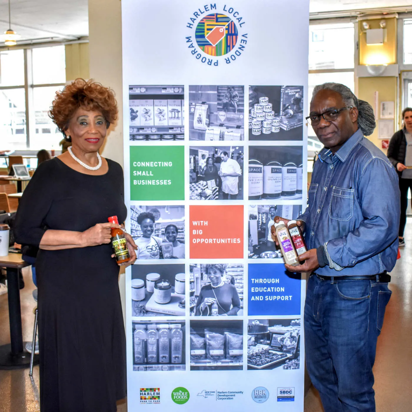 Vendors pose for a photo with their product