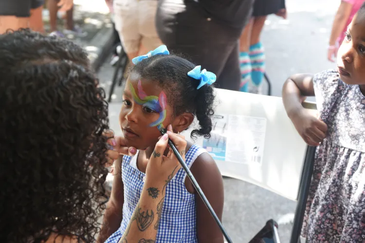  Face painting fun, courtesy of Indiglo Entertainment, was on the lineup of festivities at the back-to-school block party. Photo credit: Susan Farley