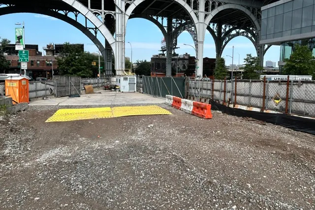 Site 4, which is covered with a flat layer of gravel, with the Viaduct in the background.