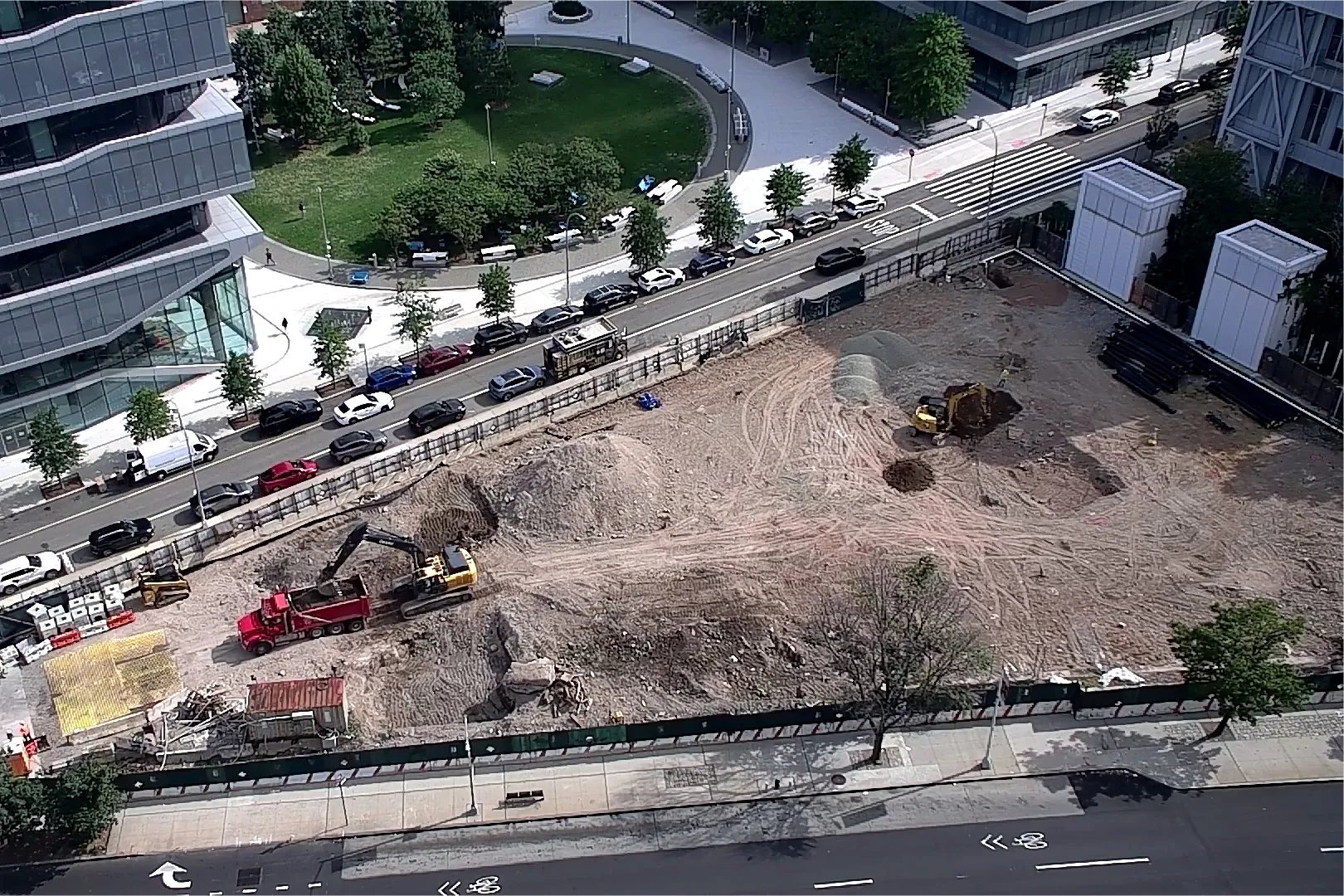 An aerial view of Site 4, which is covered with dirt, with Columbia Business School and The Square north. 