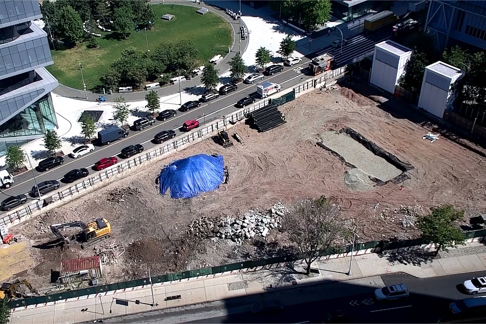 An aerial view of Site 4, which is covered with dirt, with Columbia Business School and The Square north. 