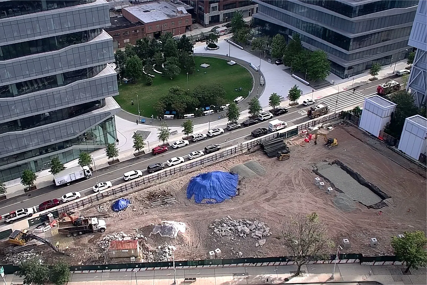 An aerial view of Site 4, which is covered with dirt, with Columbia Business School and The Square north. 