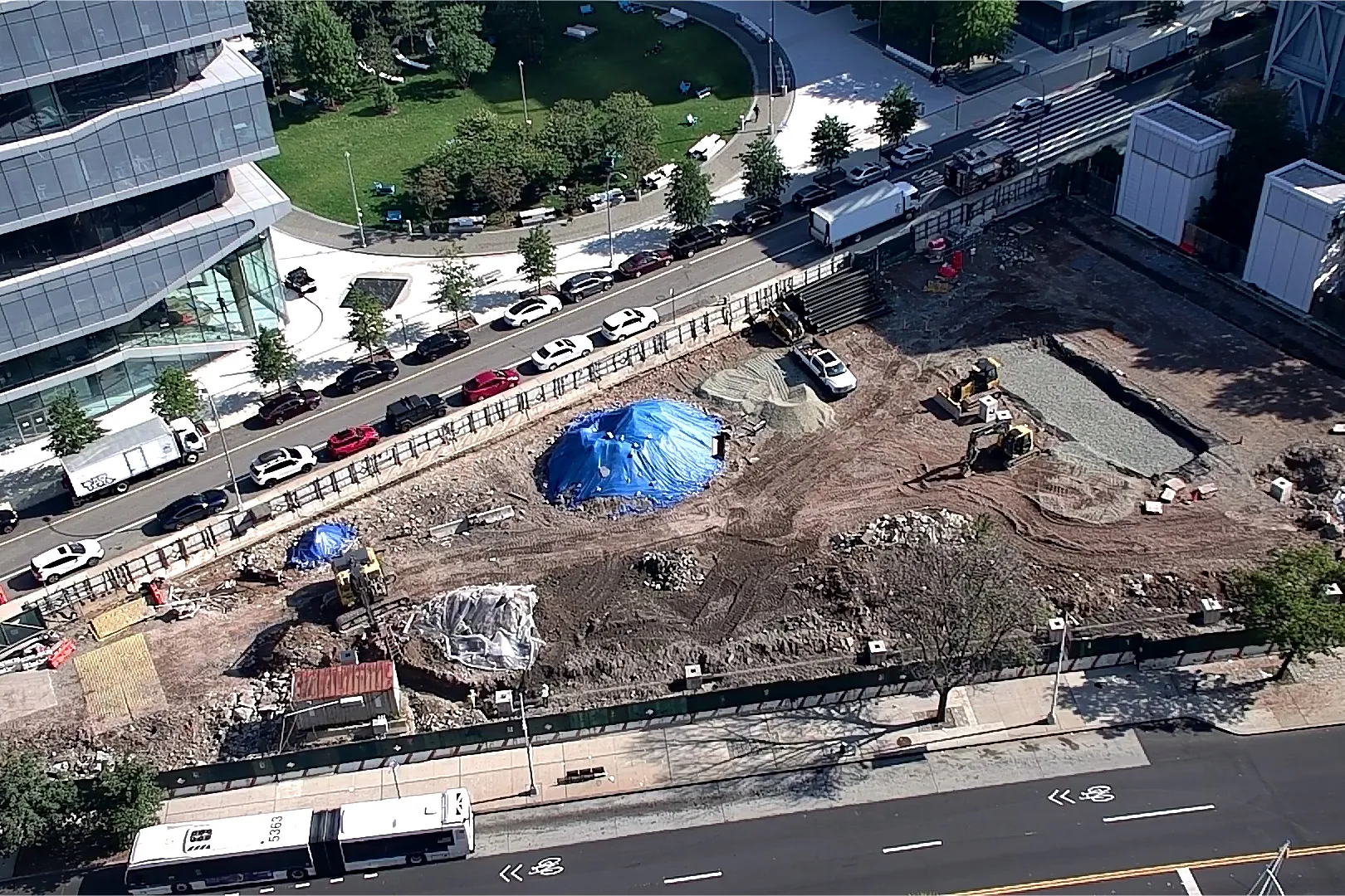 An aerial view of Site 4, which is covered with dirt, with Columbia Business School and The Square north. 