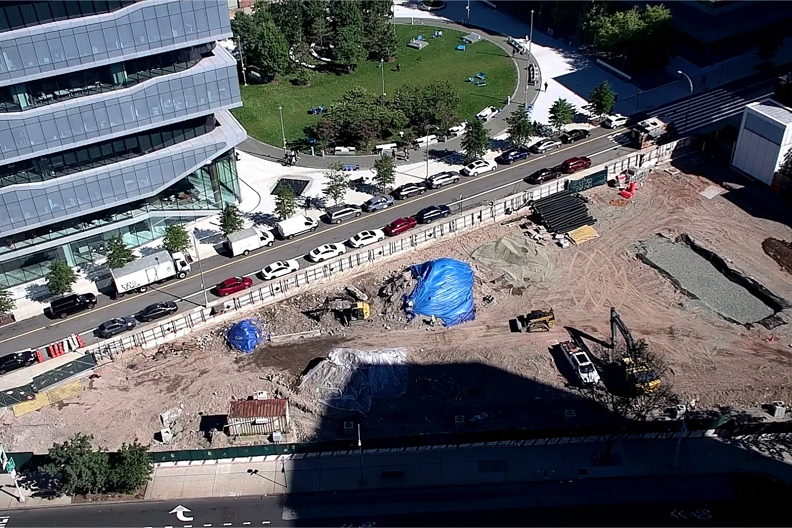 An aerial view of Site 4, which is covered with dirt, with Columbia Business School and The Square north. 