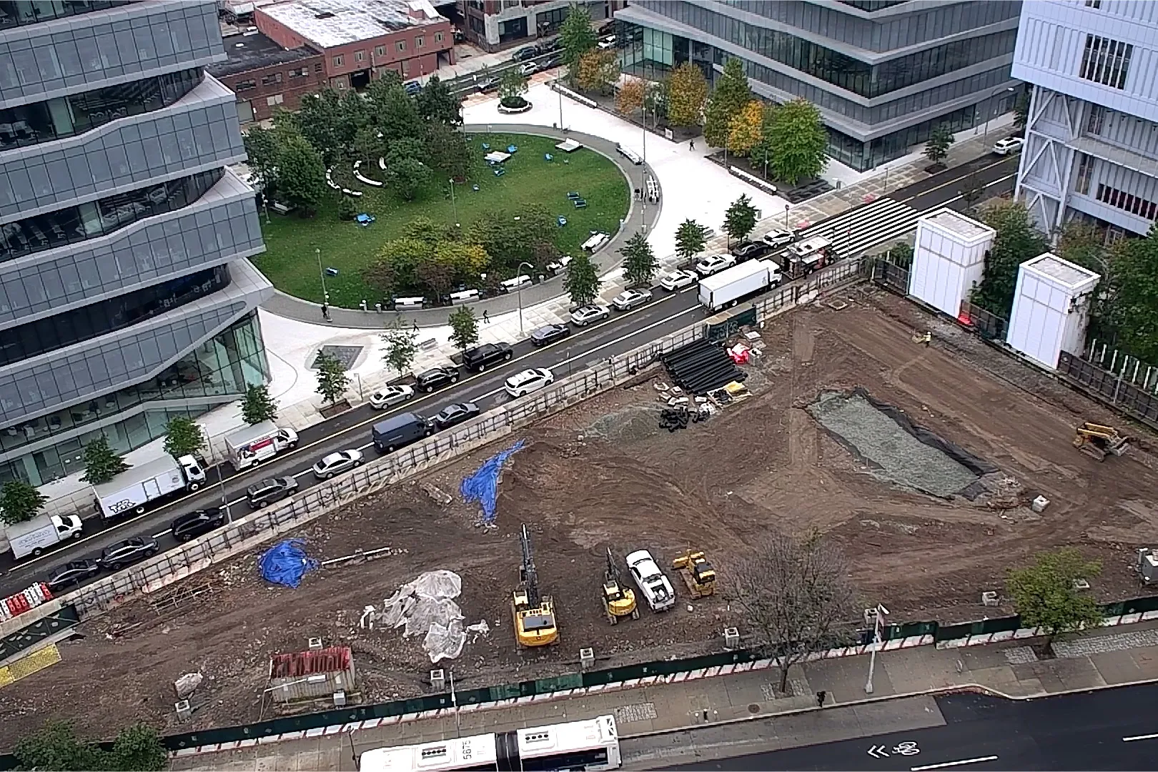 An aerial view of Site 4, which is covered with dirt, with Columbia Business School and The Square north. 