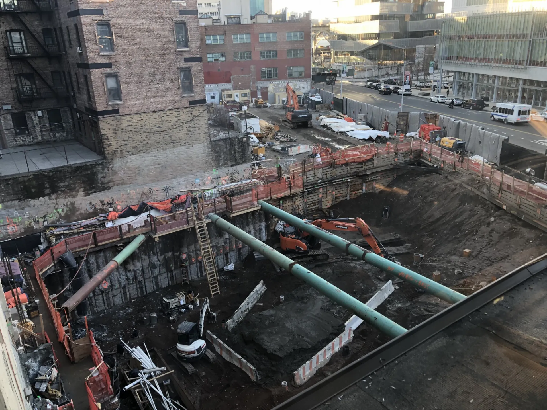 A view of the 600 W. 125th Street construction site with equipment and support pipes running across.  