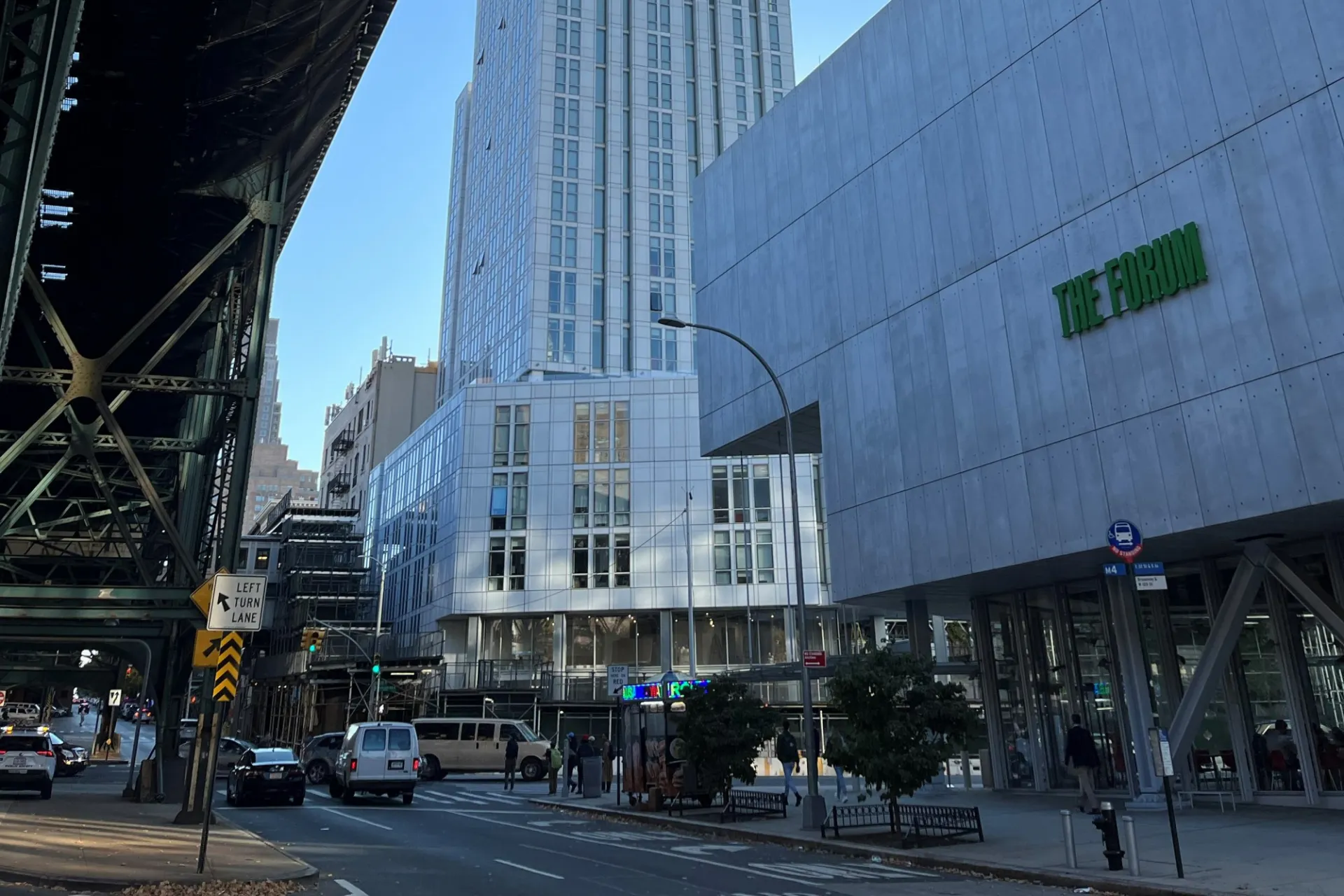 A street view of 600 W. 125th Street with The Forum and the 125th Street 1 train in the foreground.