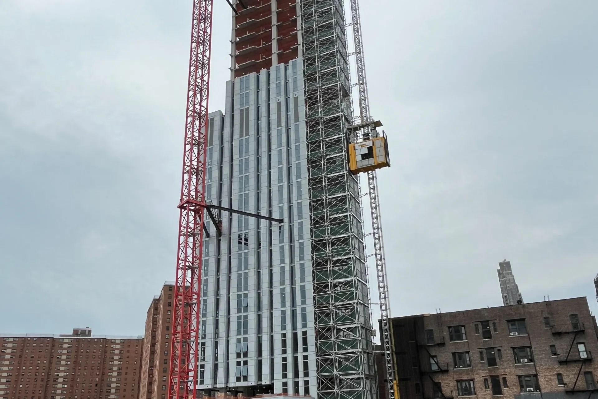 A view of the 600 W. 125th Street construction site which is 35 floors high, and has facade panels installed around it. 