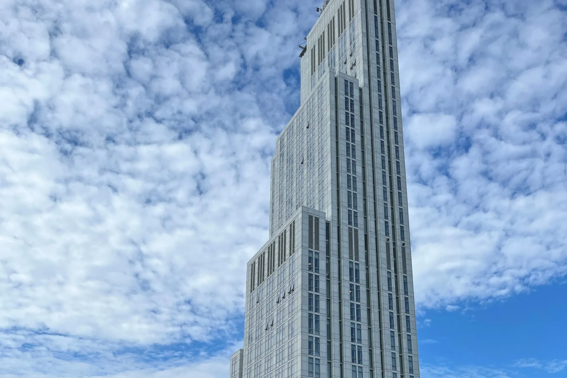 A view of the upper floors of 600 W. 125th Street, looking southeast, on a partly cloudy day. 