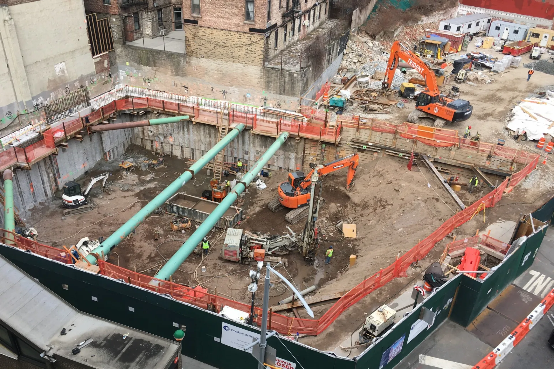 A view of the 600 W. 125th Street construction site with equipment and support pipes running across. Foundation work being performed on a construction site.  