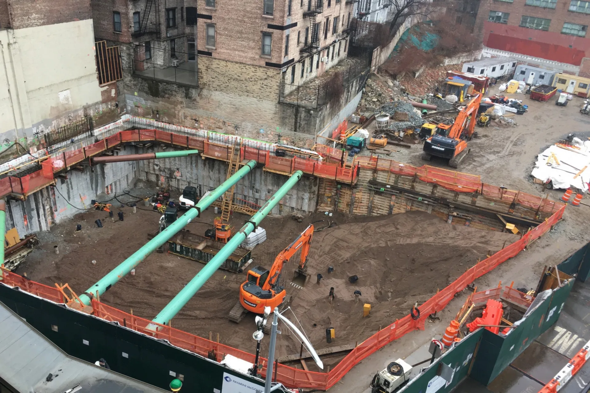A view of the 600 W. 125th Street construction site with equipment and support pipes running across. Foundation work being performed on a construction site.  
