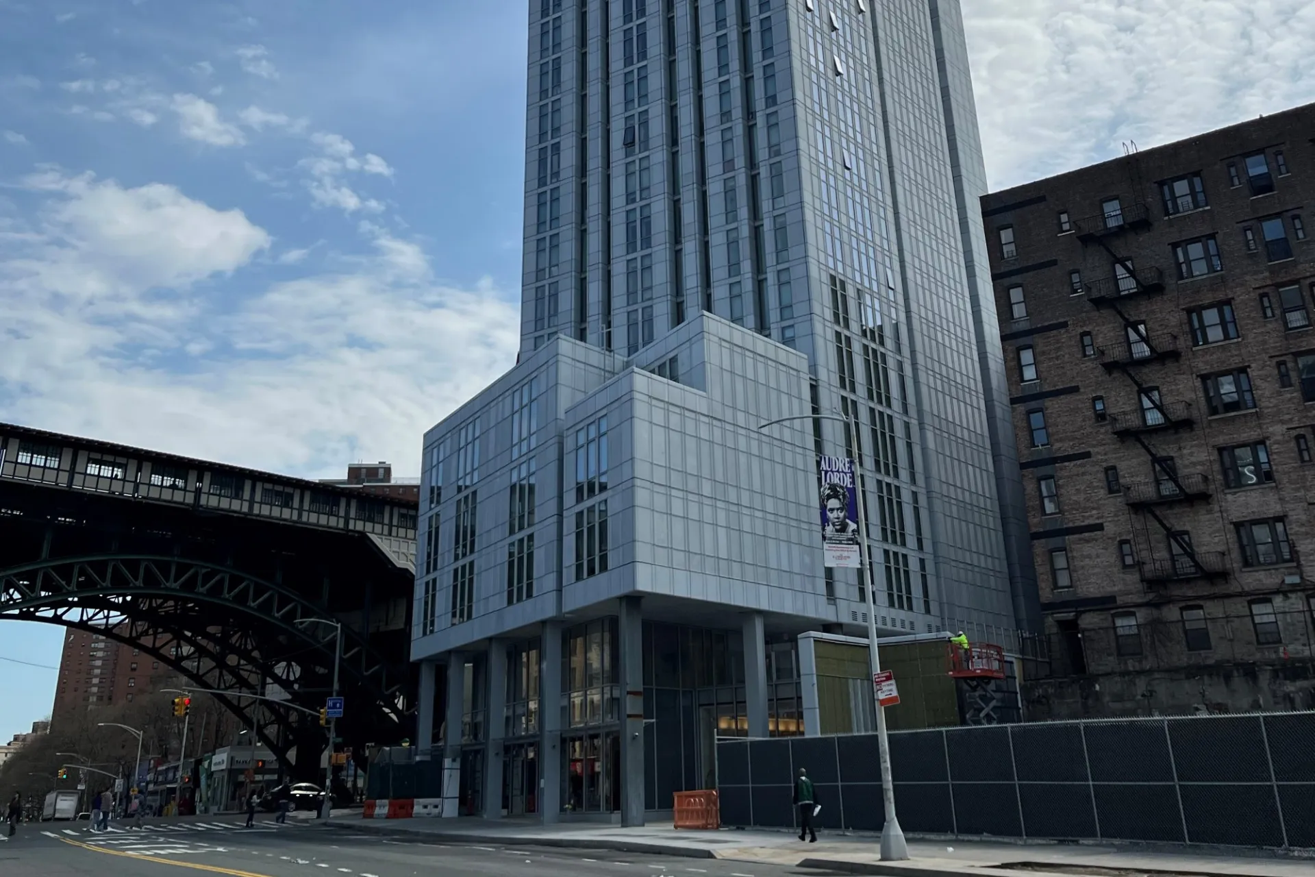 A view of the lower floors of 600 W. 125th Street with the elevated 1 train in the background.