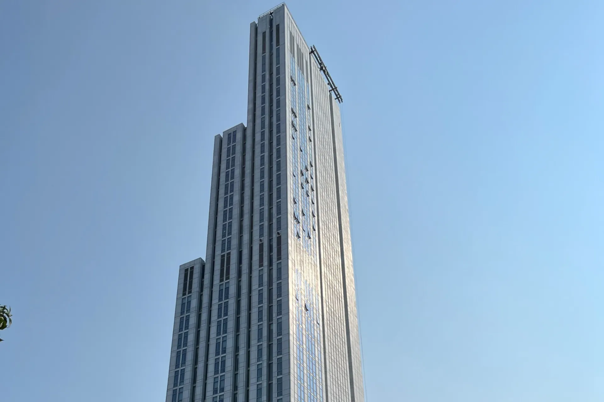 A view of the upper floors of 600 W. 125th Street, looking southeast, on a clear sky day.