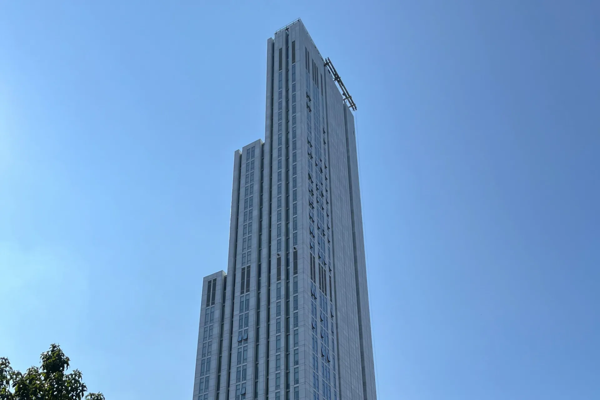 A view of the upper floors of 600 W. 125th Street, looking southeast, on a clear sky day. 