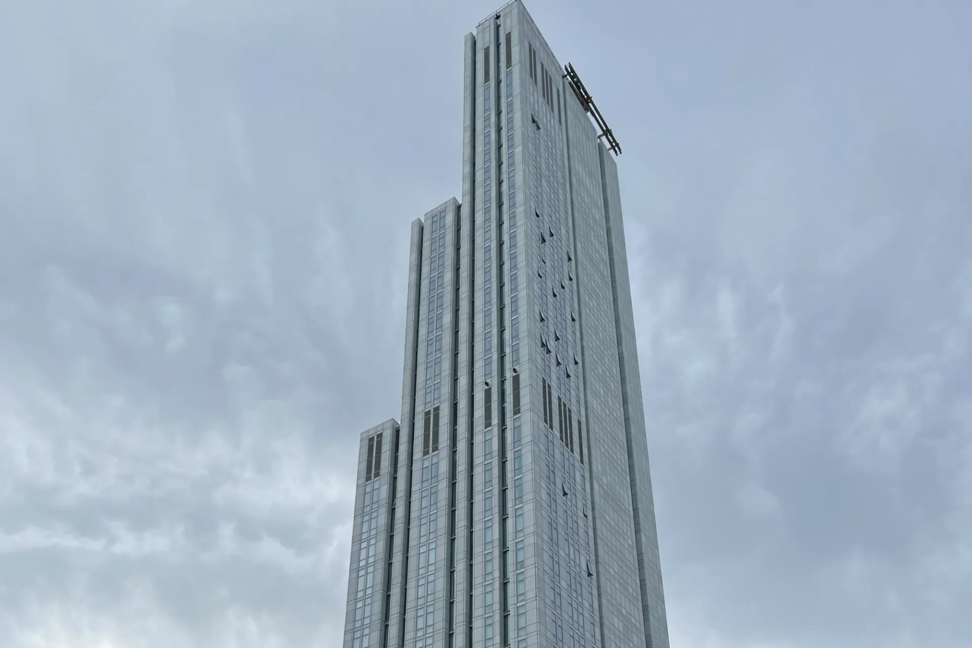 A view of the upper floors of 600 W. 125th Street, looking southeast on a cloudy day. 