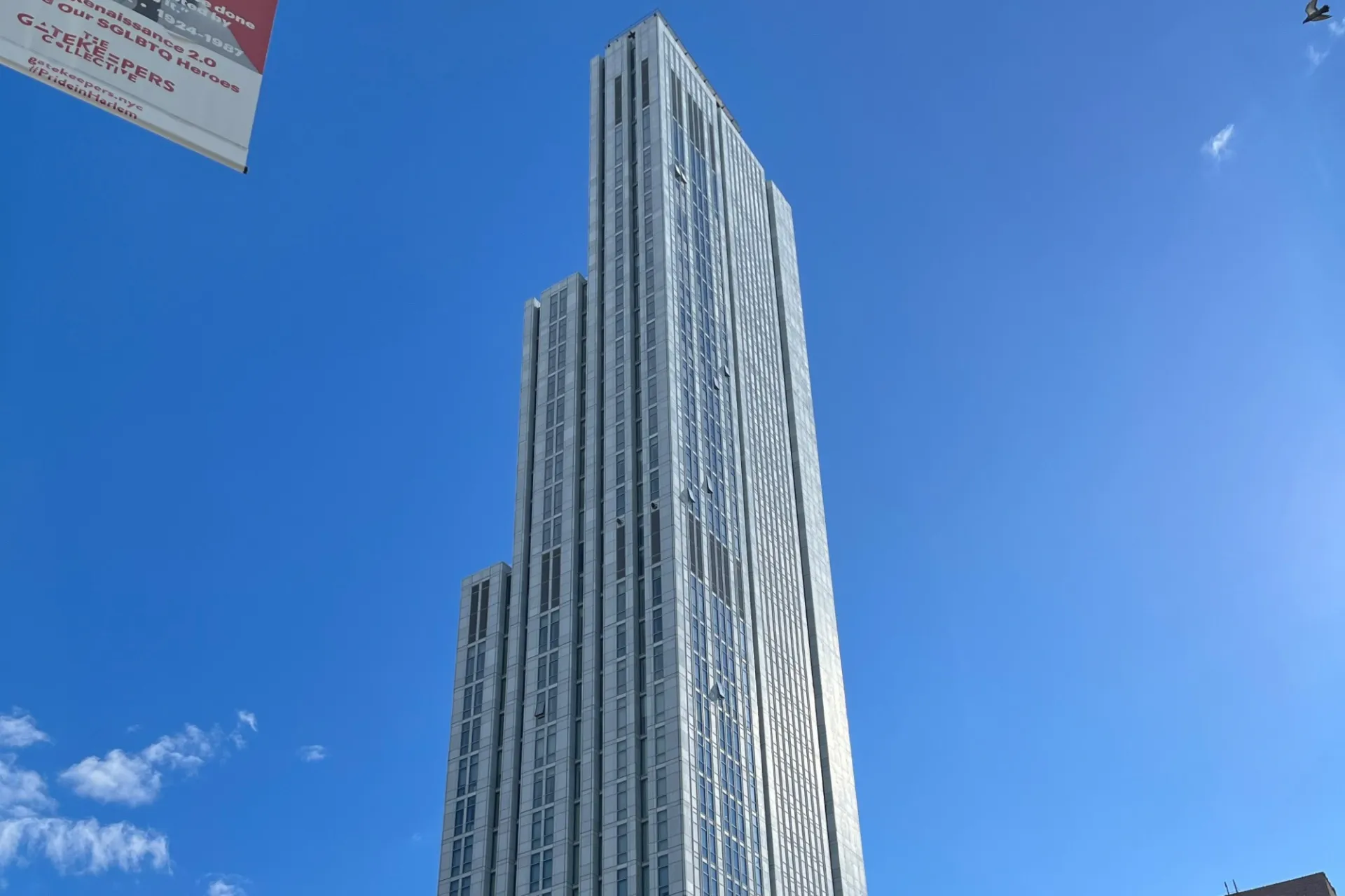A view of the upper floors of 600 W. 125th Street, looking southeast on a sunny day.