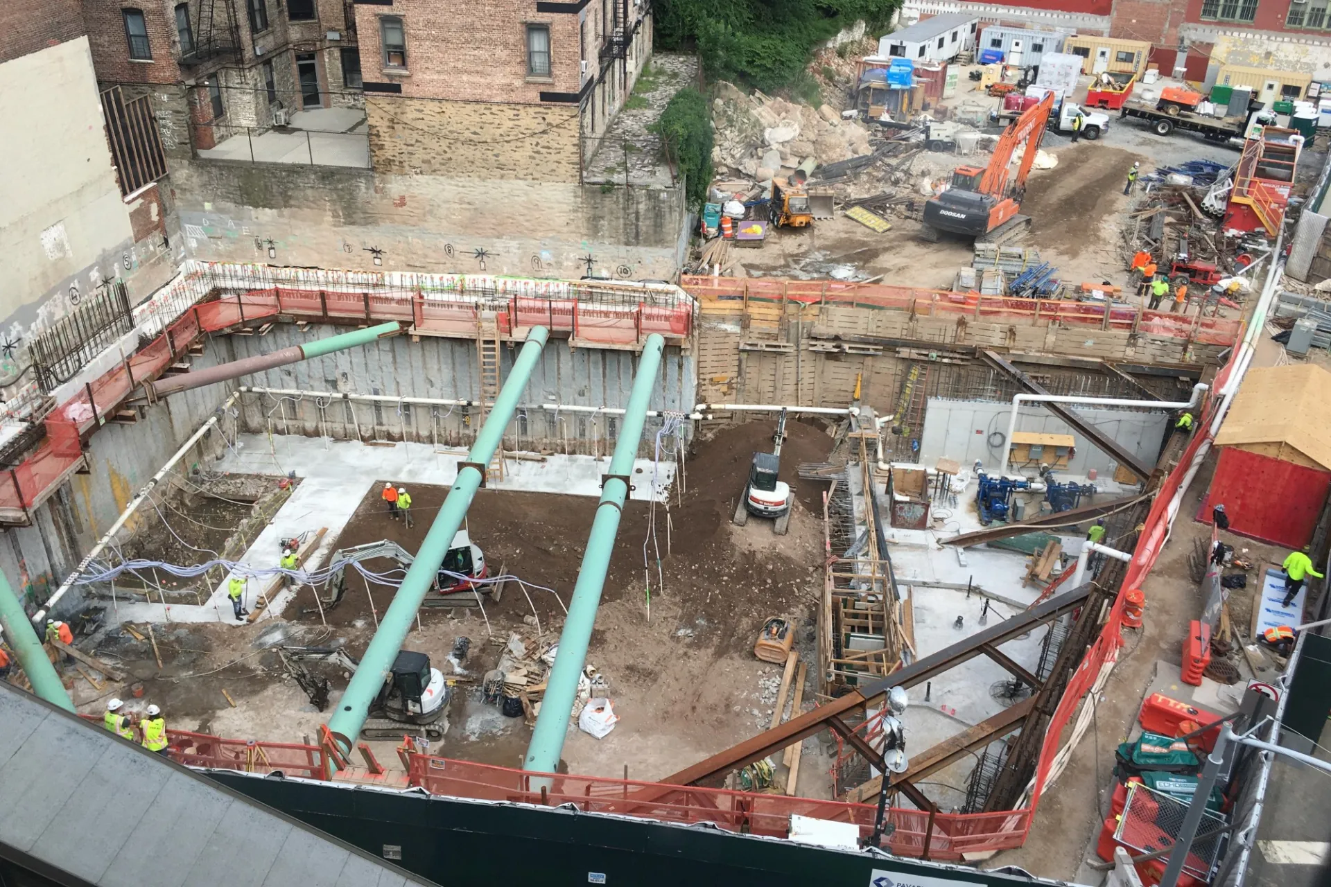 A view of the 600 W. 125th Street construction site with rebars along the perimeter of the northern portion of the site with steel beams overhead.