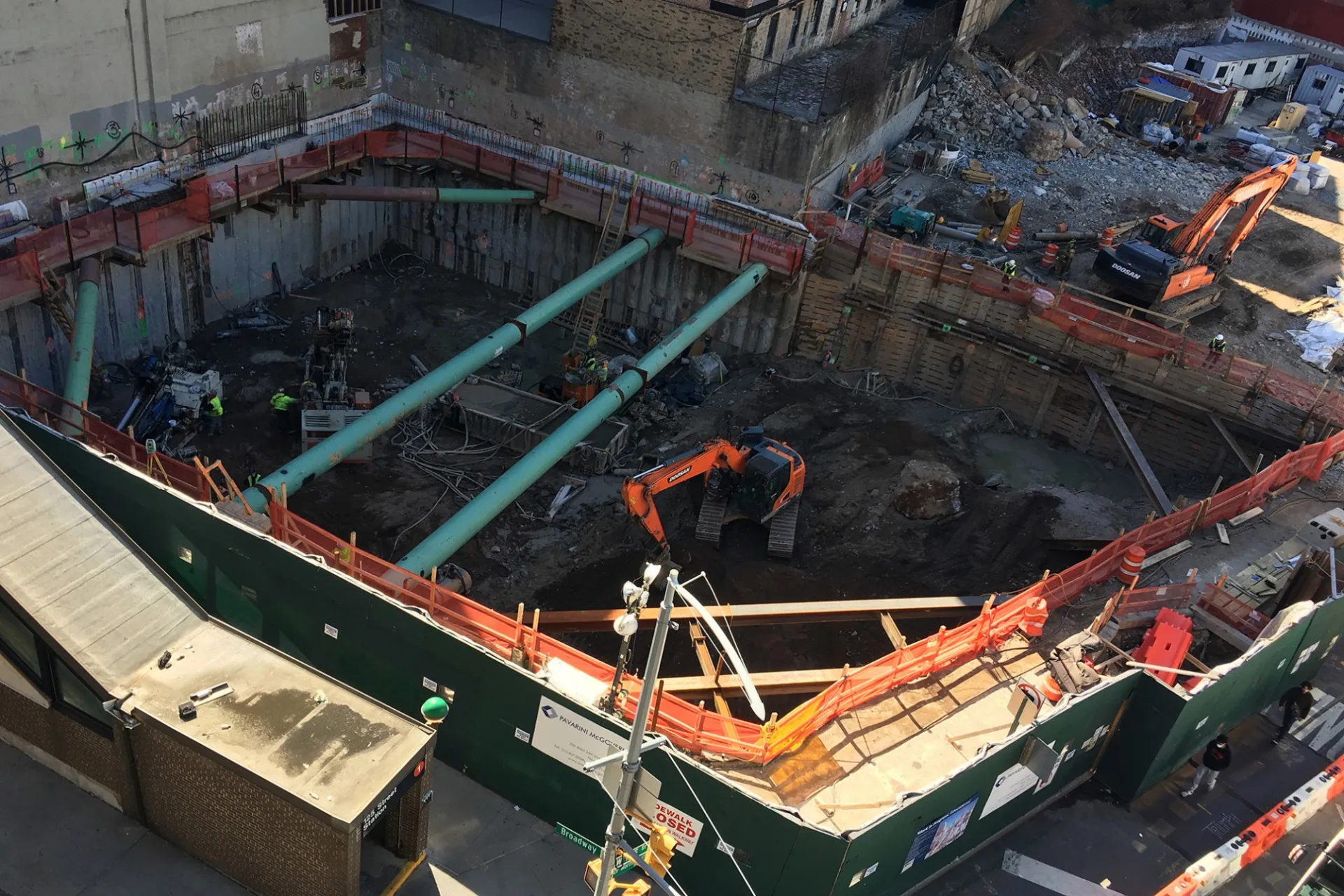 A view of the 600 W. 125th Street construction site with equipment and support pipes running across. Foundation work being performed on a construction site.  