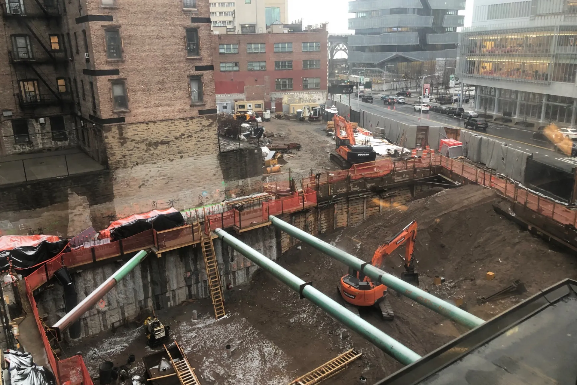 A view of the 600 W. 125th Street construction site with equipment and support pipes running across. Foundation work being performed on a construction site.  