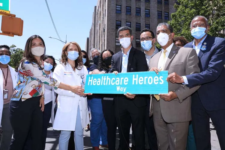 group of people posing for photo with street sign