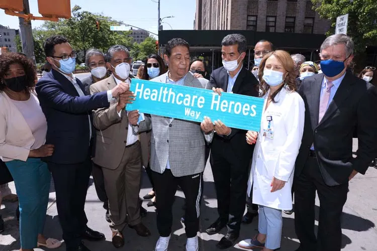group of people posing for photo with street sign