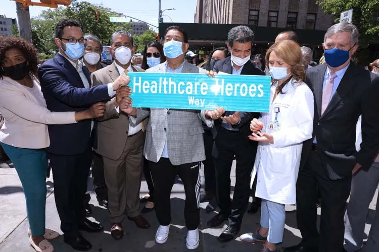 group of people posing for photo with street sign