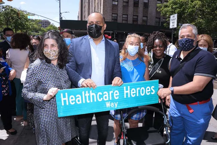 group of people posing for photo with street sign