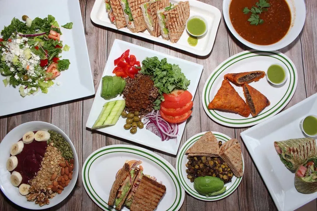 An overhead shot of different Ethiopian meals offered at Oasis Jimma Juice Bar.